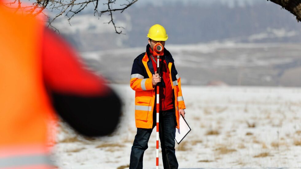 land-surveying-expert two surveyors measuring with tools